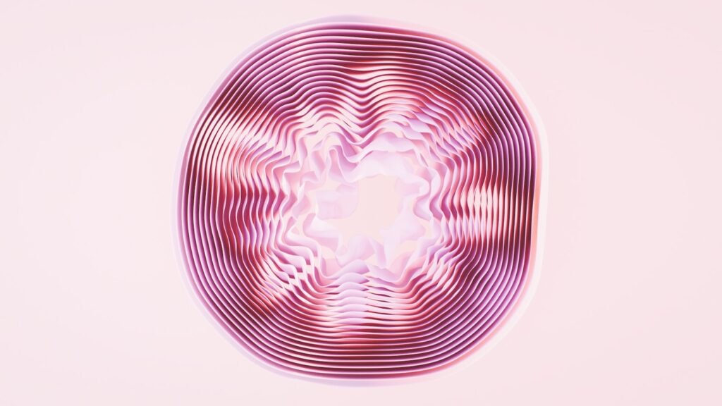 A pink circular object with a white background