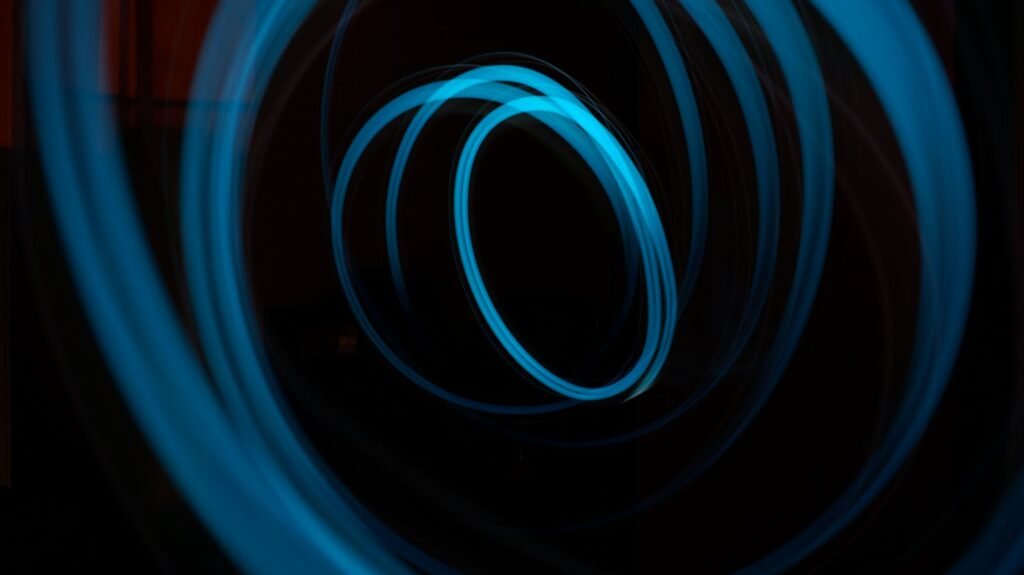 Captivating abstract light painting featuring illuminated blue circles on a dark background.