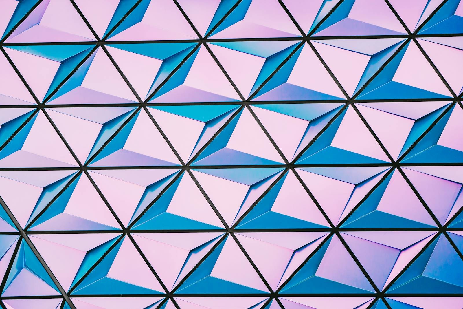 A vibrant triangular pattern with shades of pink and blue for modern backgrounds.