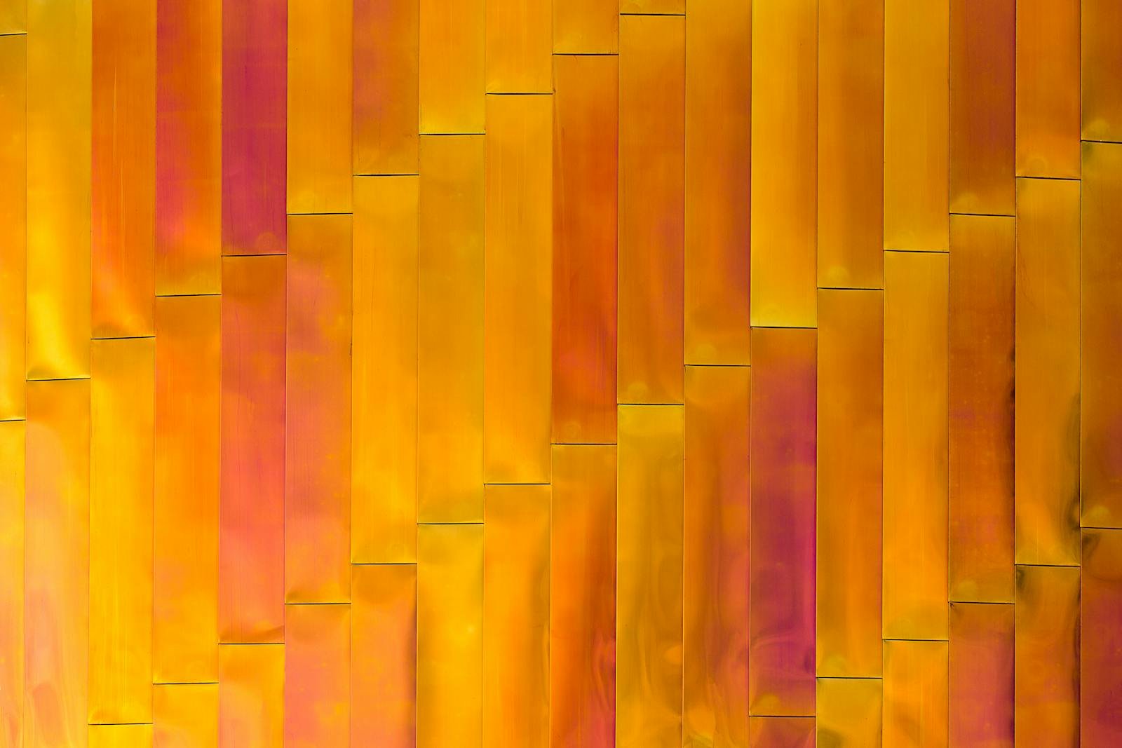 Colorful abstract pattern with vertical planks in yellow and orange hues. Ideal for backgrounds or design projects.