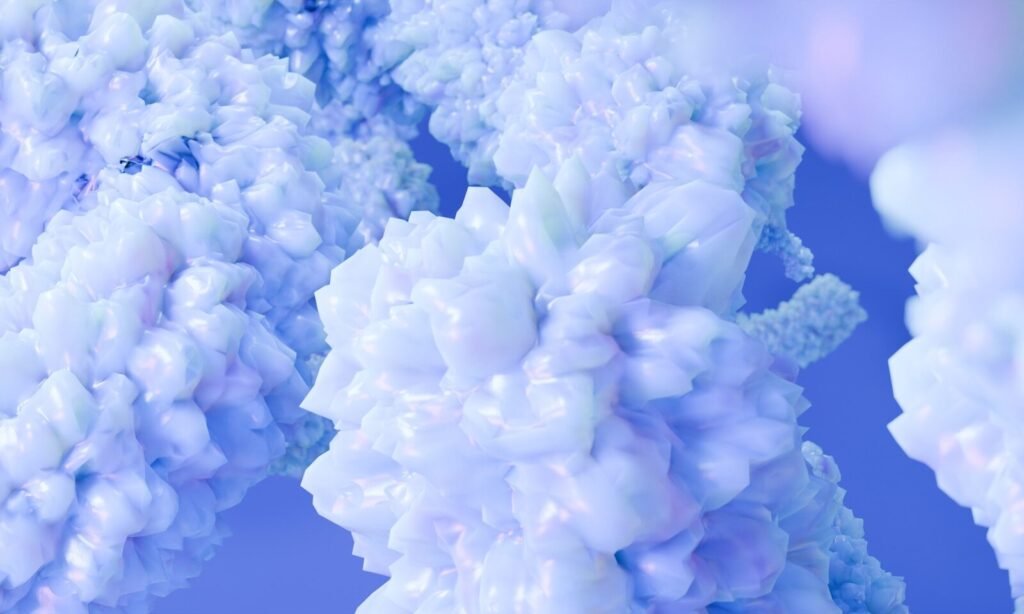 Abstract clusters of pale blue crystalline forms against a solid blue background