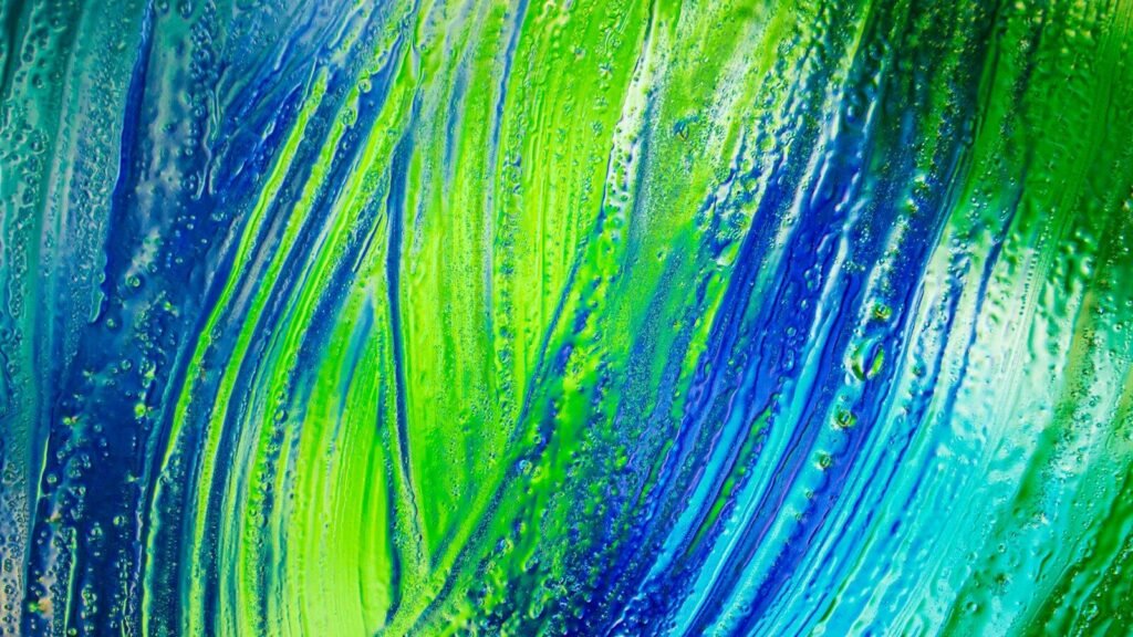 Abstract streaks of vibrant blue and lime green paint with a textured water droplet surface